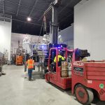 IRH team member uses a Versa-Lift to move production equipment.