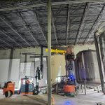 IRH crews lift equipment pieces for assembly of a new production line.