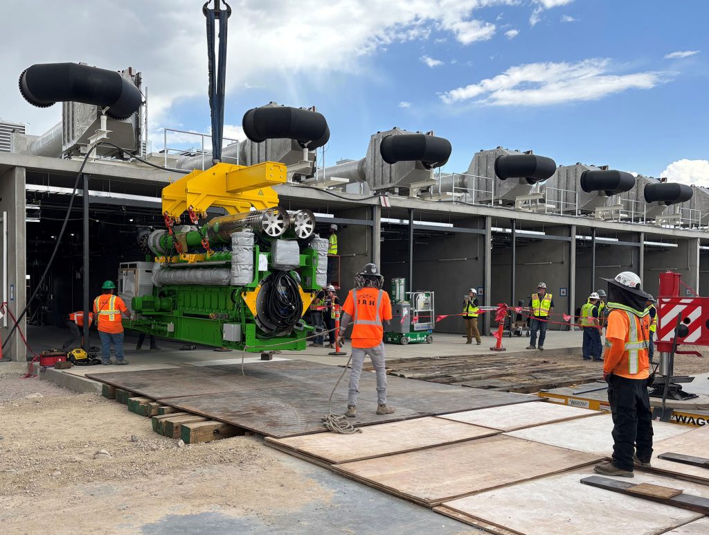 IRH rigging crew members installing equipment at a generator plant.