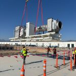 The IRH rigging crew holding tag lines while lifting heavy equipment.