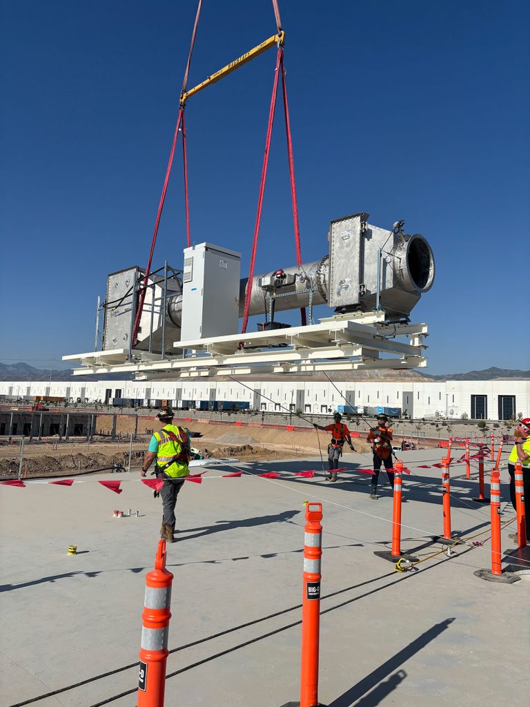 The IRH rigging crew holding tag lines while lifting heavy equipment.