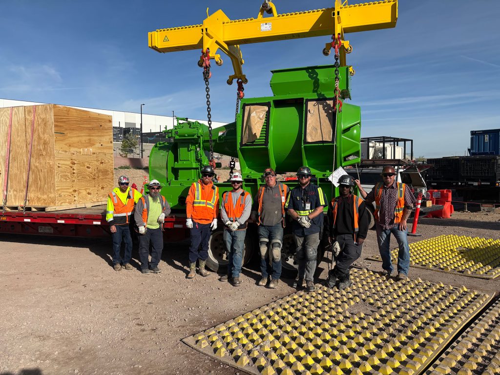 The IRH crew standing in front of a generator at a data center power generator plant.